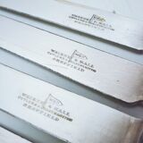 Set of four silver metal knives