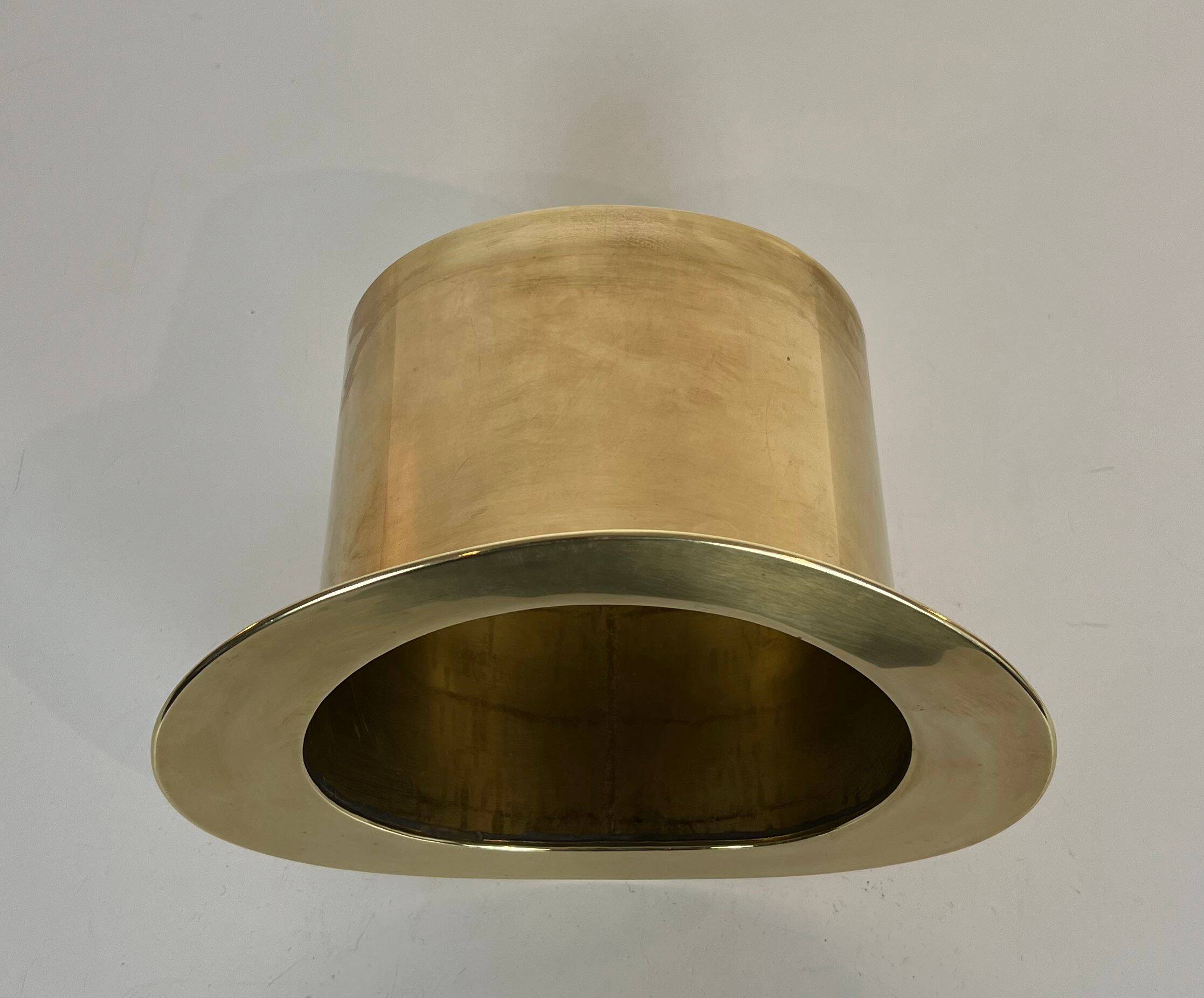 Champagne cooler shaped like a brass top hat.