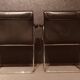 Pair of black leather Scandinavian armchairs
