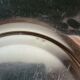 Shallow round metal plate with pearl row decoration.