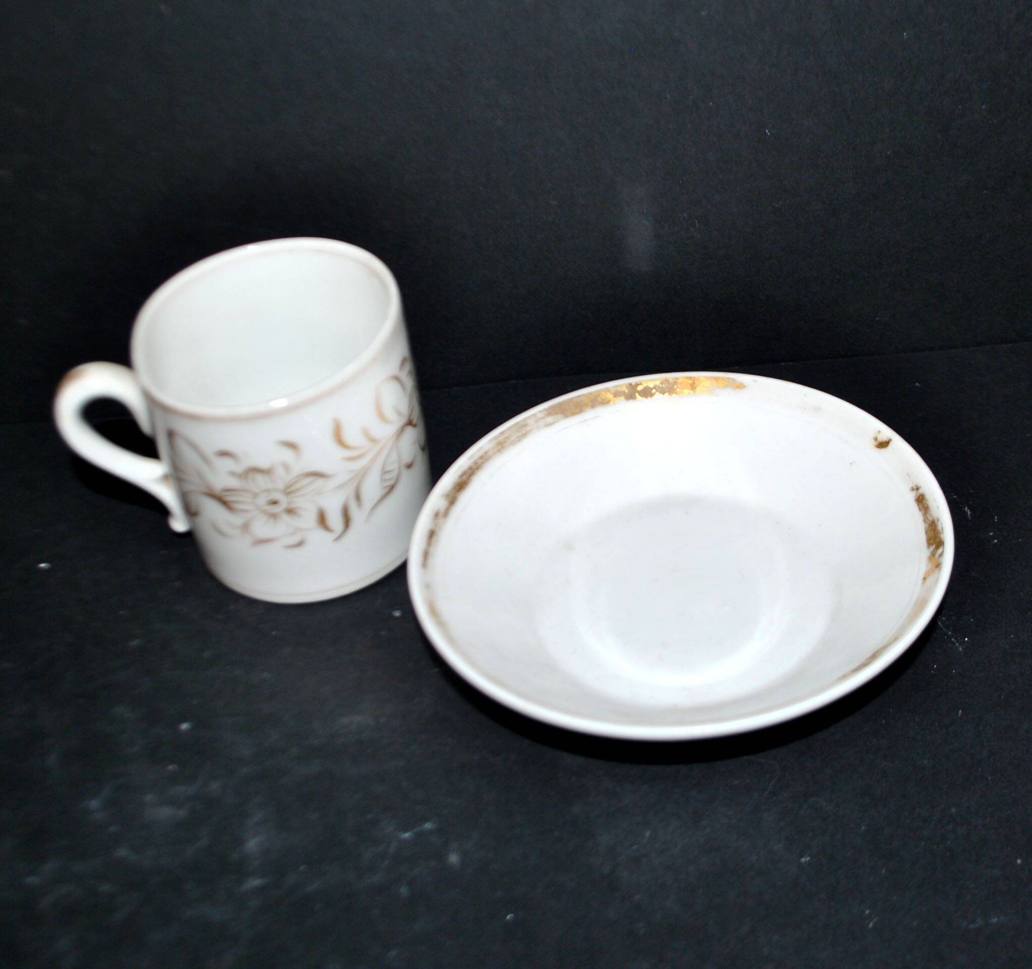 Paris porcelain coffee cup with floral design, antique porcelain with gold trim.