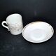 Paris porcelain coffee cup with floral design, antique porcelain with gold trim.