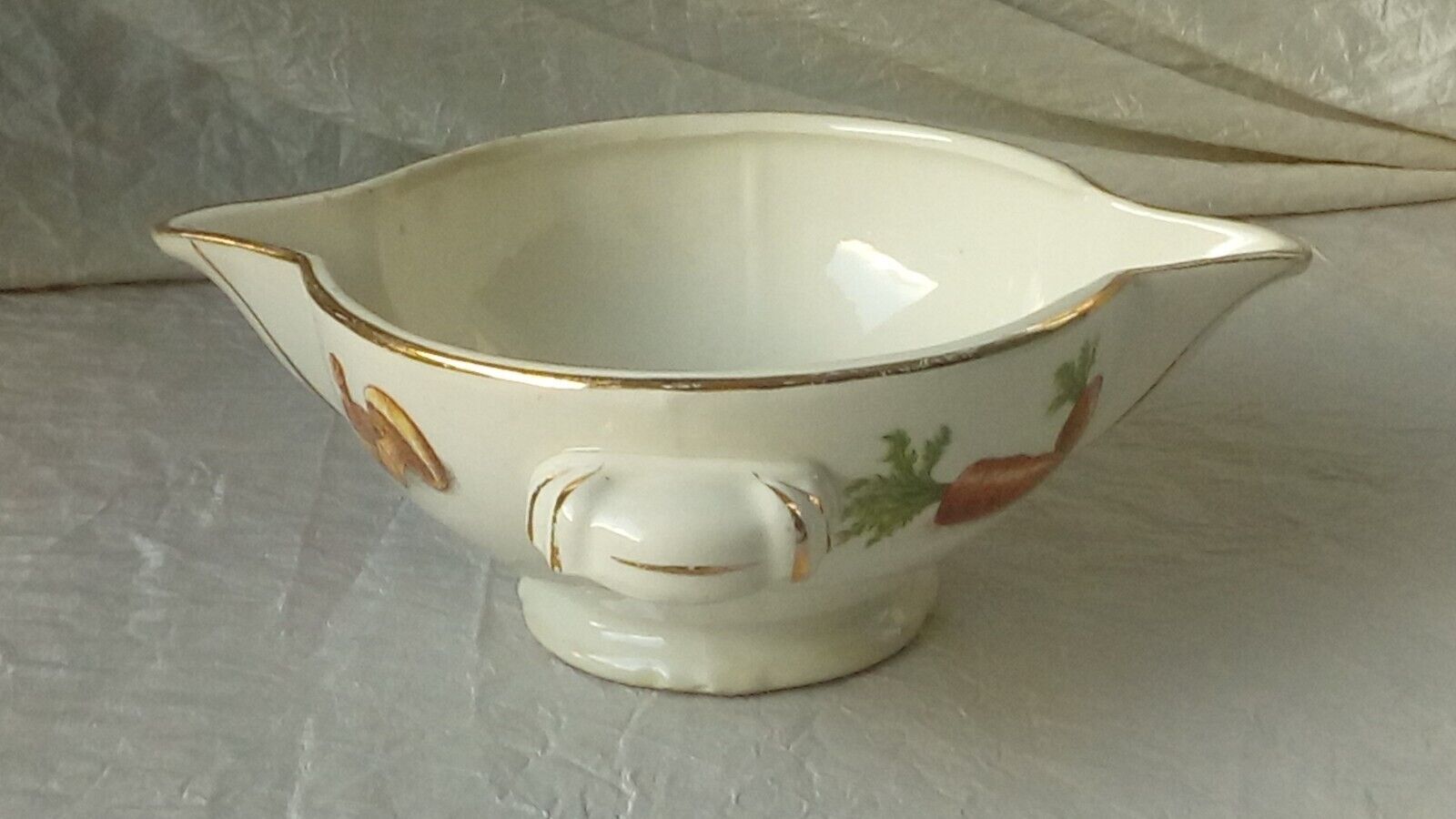 Sauceboat in earthenware decorated with four seasons vegetables.