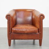 Cognac-colored cow leather club chair finished with decorative nails in English style