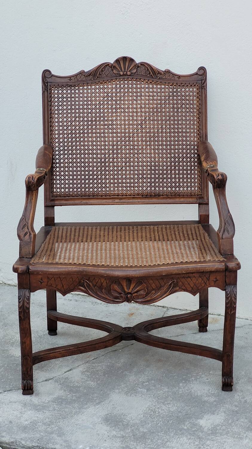 Louis XV Regency cane armchair leather armrests decorated with shell