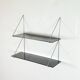 Mid-century vintage shelf in a loop shape, black glass and metal.