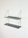 Mid-century vintage shelf in a loop shape, black glass and metal.