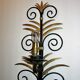 Wrought iron sconces decorated with golden pineapple leaves