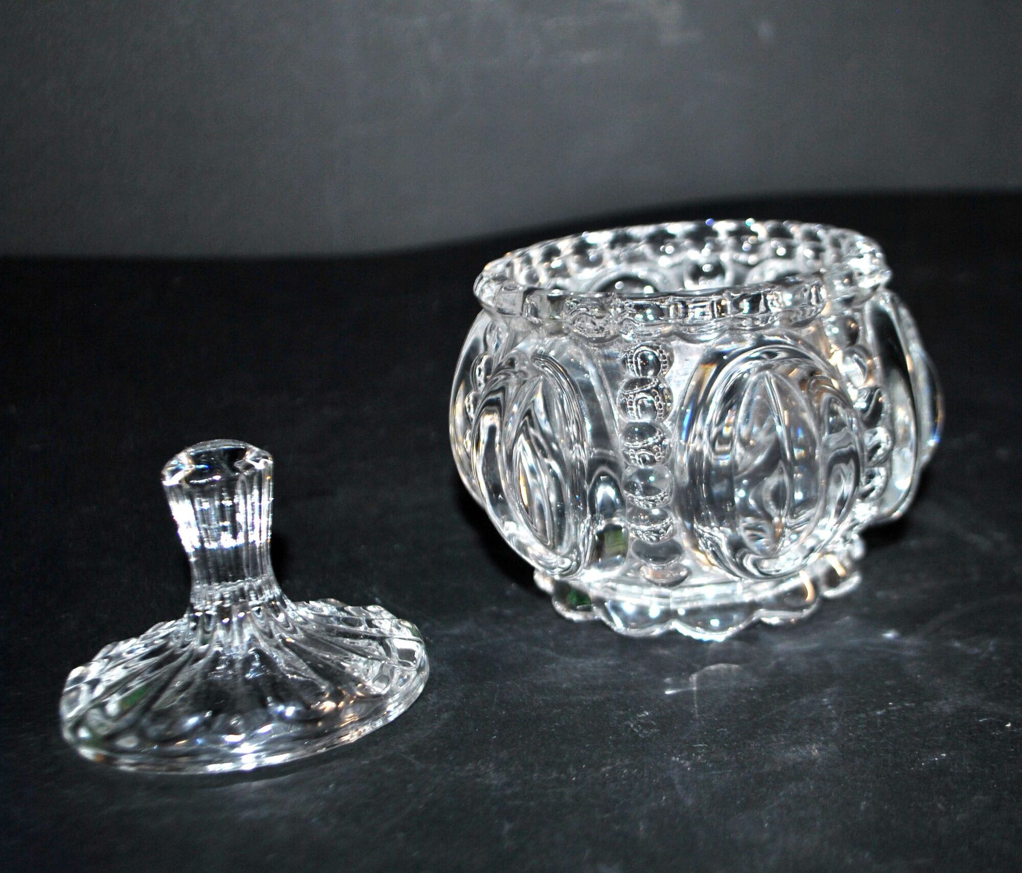 Thick moulded crystal sugar bowl with a beaded and medallion design.
