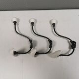 Coat hooks made of galvanized brass and raw white porcelain