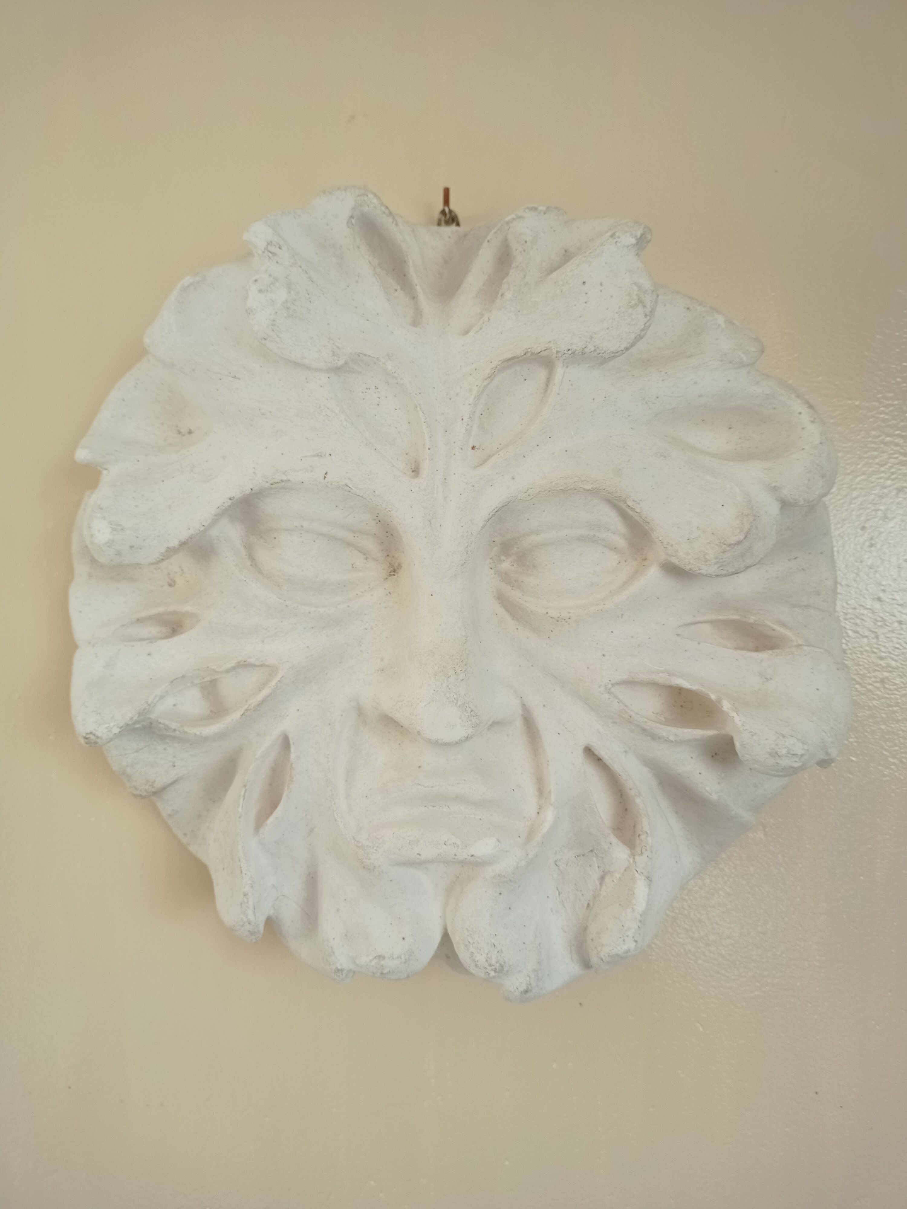 Bas relief sun in plaster