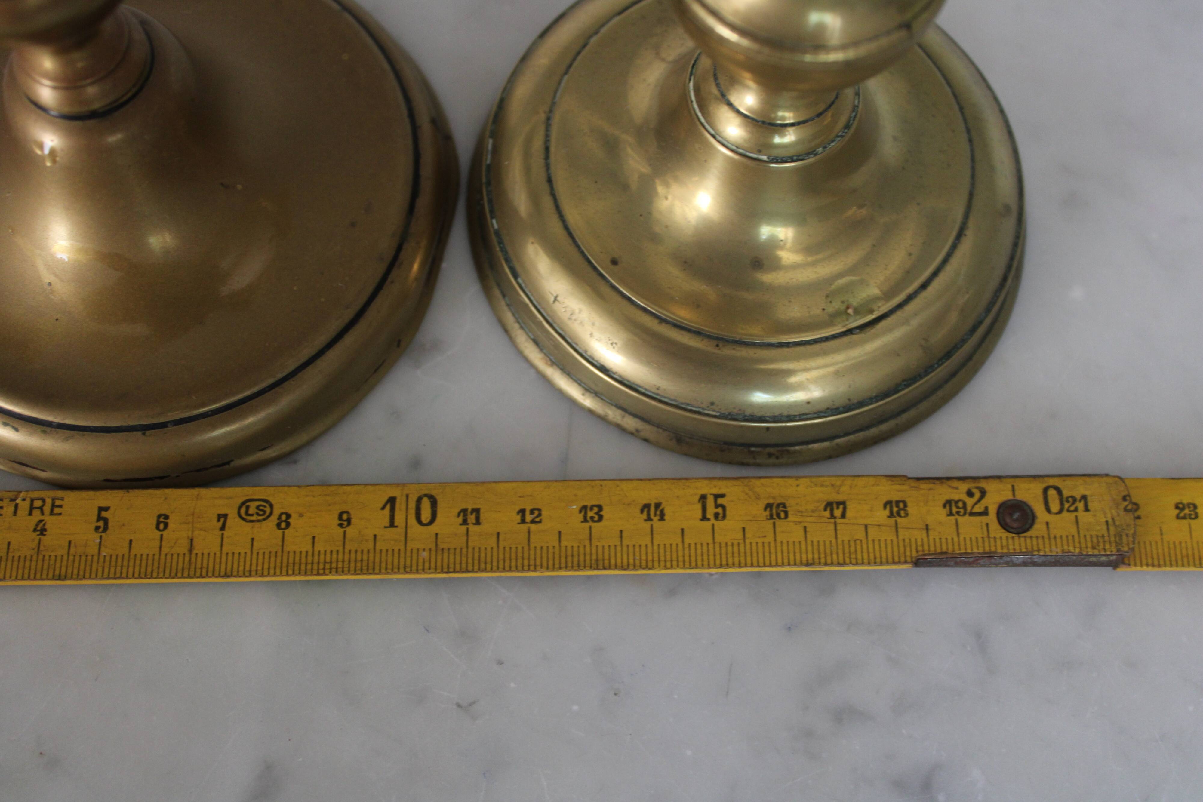 Pair of brass pusher candlesticks