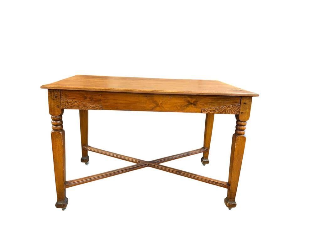 Vintage solid wood table with X-cross on wheels.