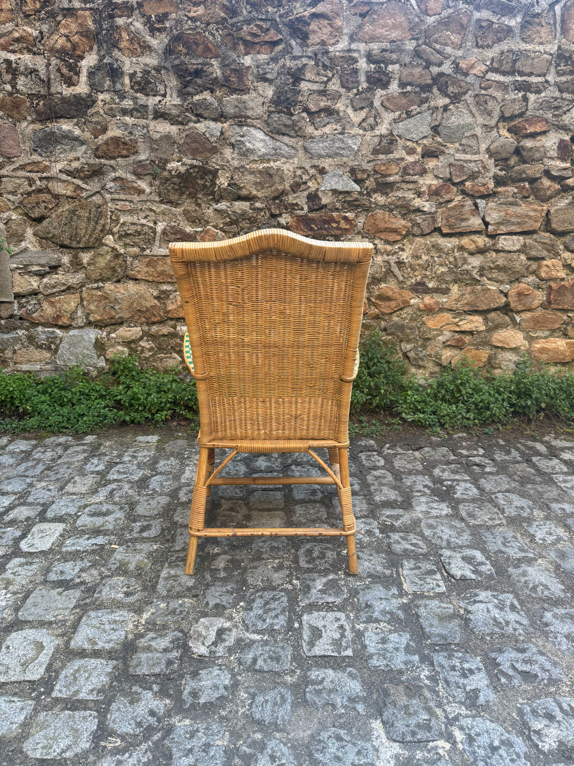 Rattan armchair with armrests