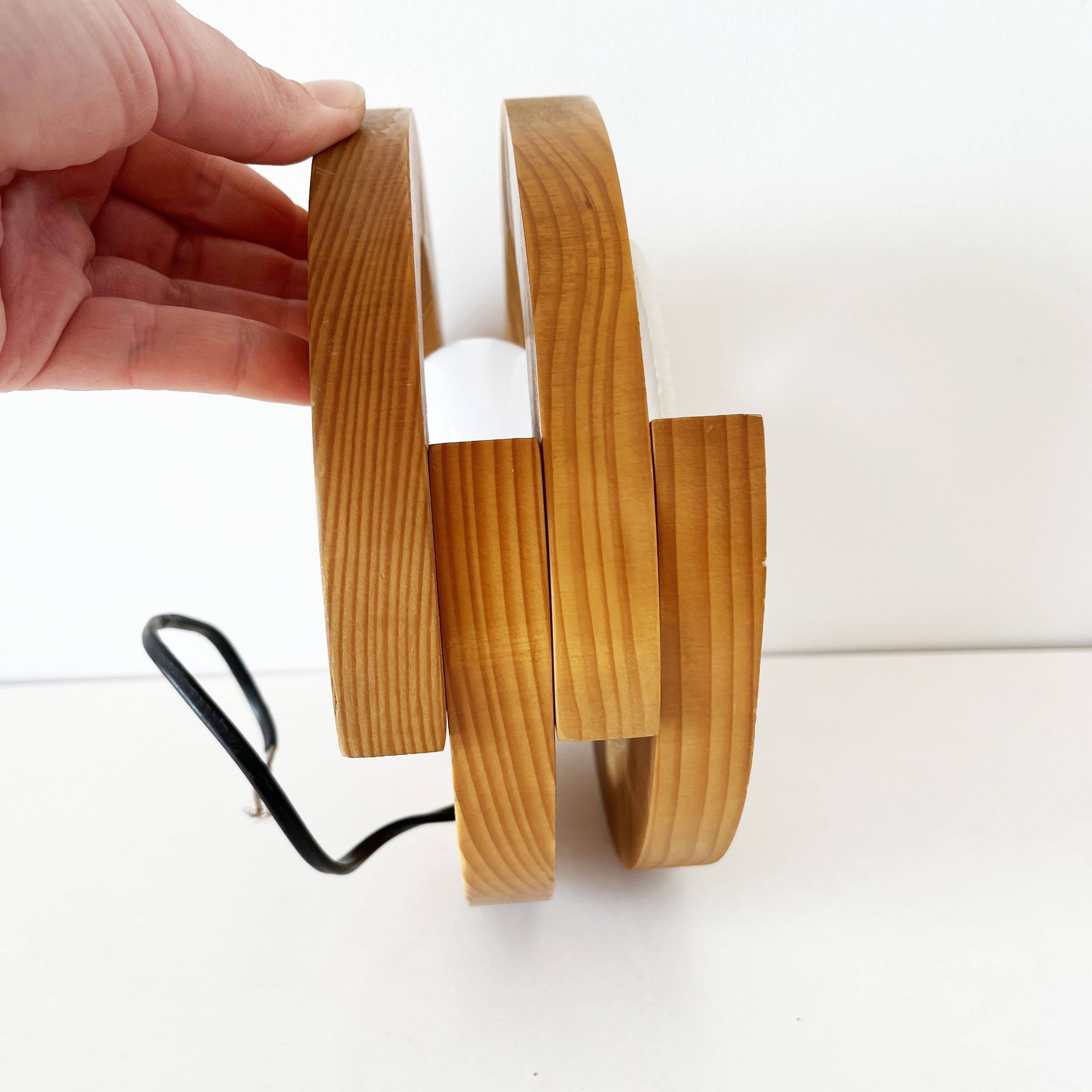 Round pine and plexiglass wall light, 1970s