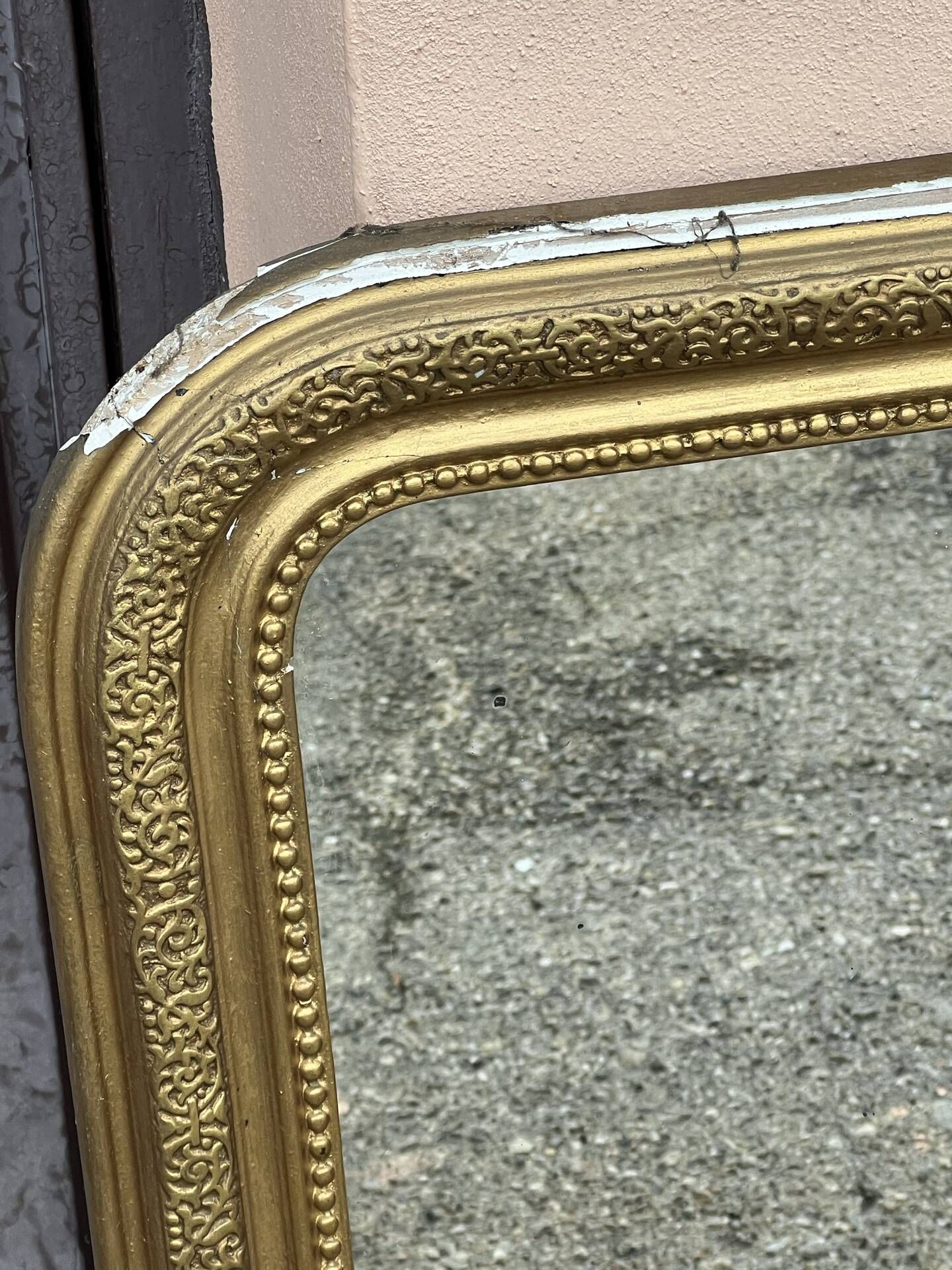 Louis Philippe mirror in gilded wood with an openwork frieze and mercury glass.