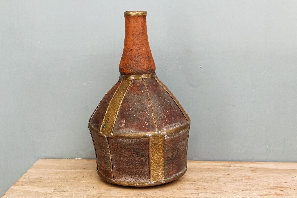 Old terracotta and brass bottle