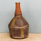 Old terracotta and brass bottle