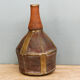 Old terracotta and brass bottle