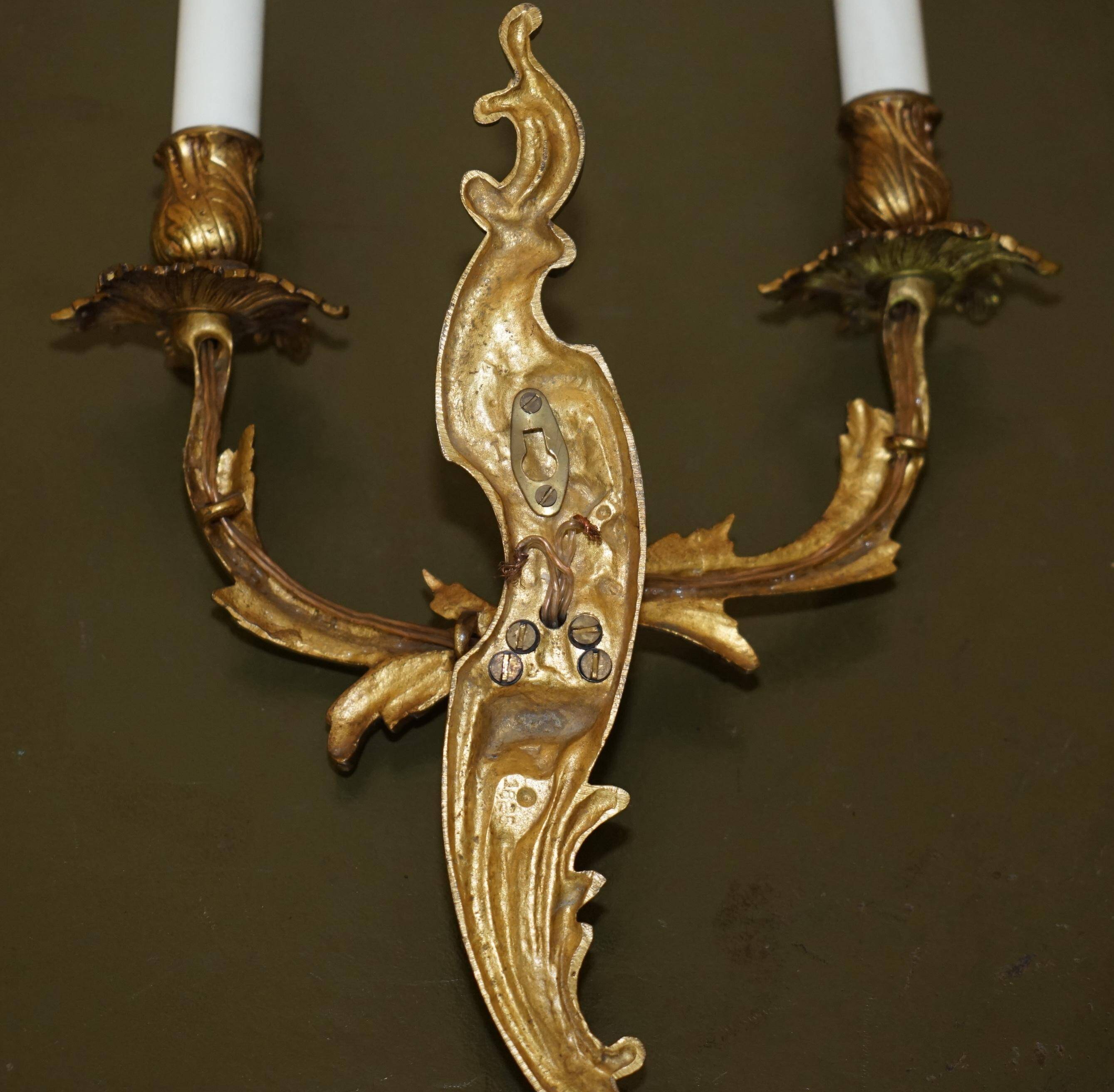 Pair of antique French wall sconces, gilded and bronzed, from the 1920s.