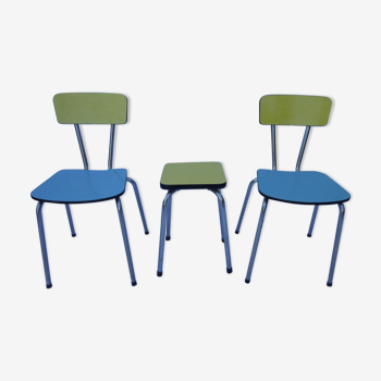 Two chairs and a yellow and blue stool in formica