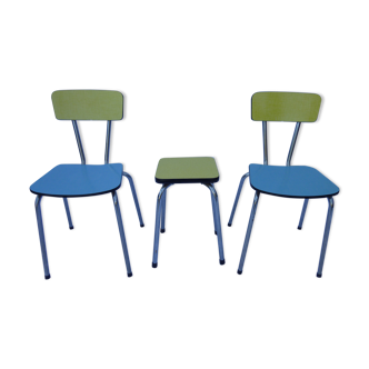 Two chairs and a yellow and blue stool in formica