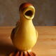 Ceramic watering can in white earthenware, yellow enamel and bird shape