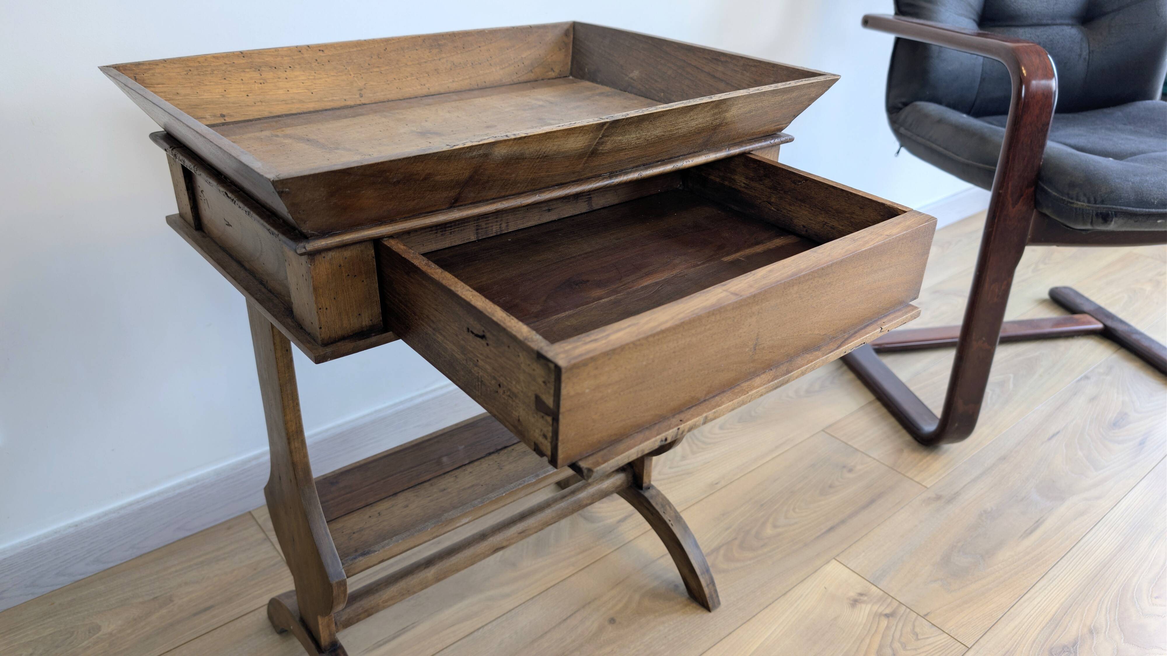 Old wooden pocket emptying table with drawer and planter.