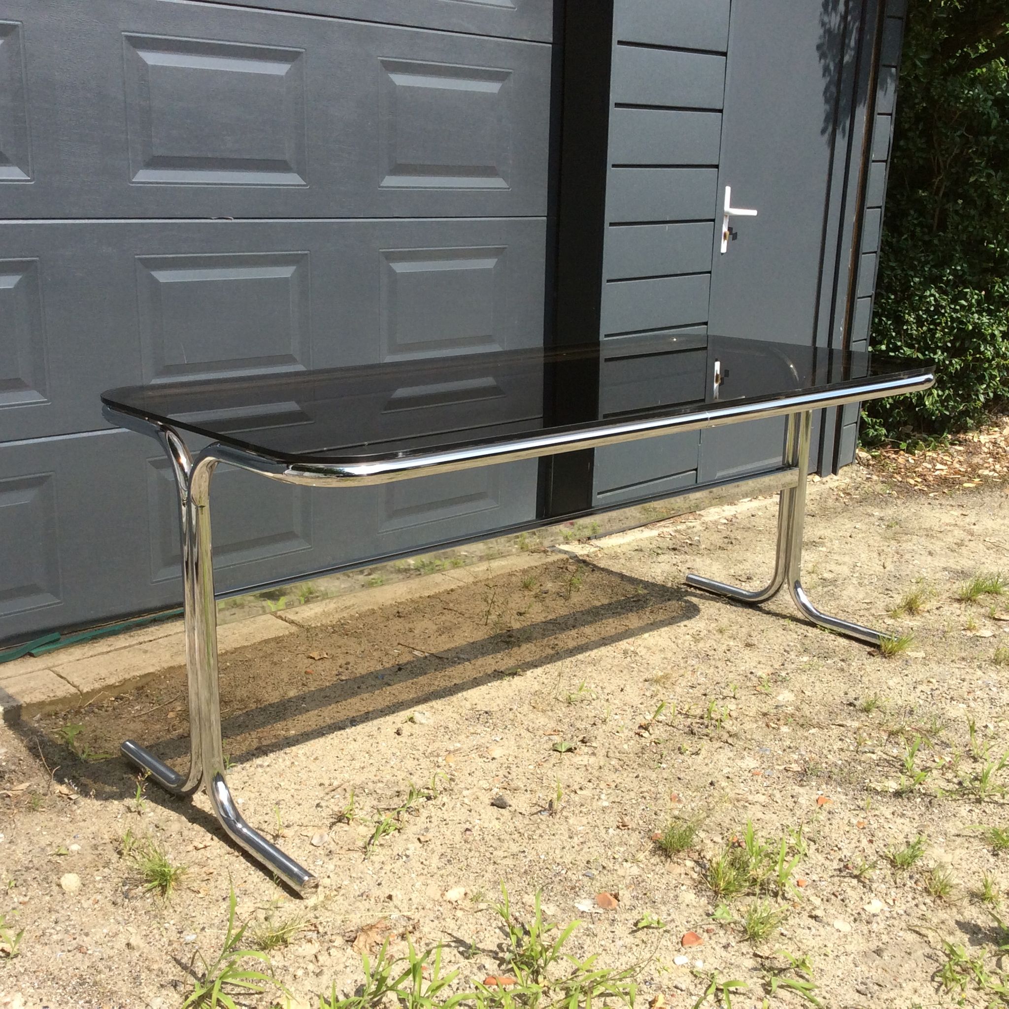 Dining table of the 70s in smoked glass and chromed metal