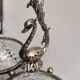 Crystal bowls joined by "swan neck" design.