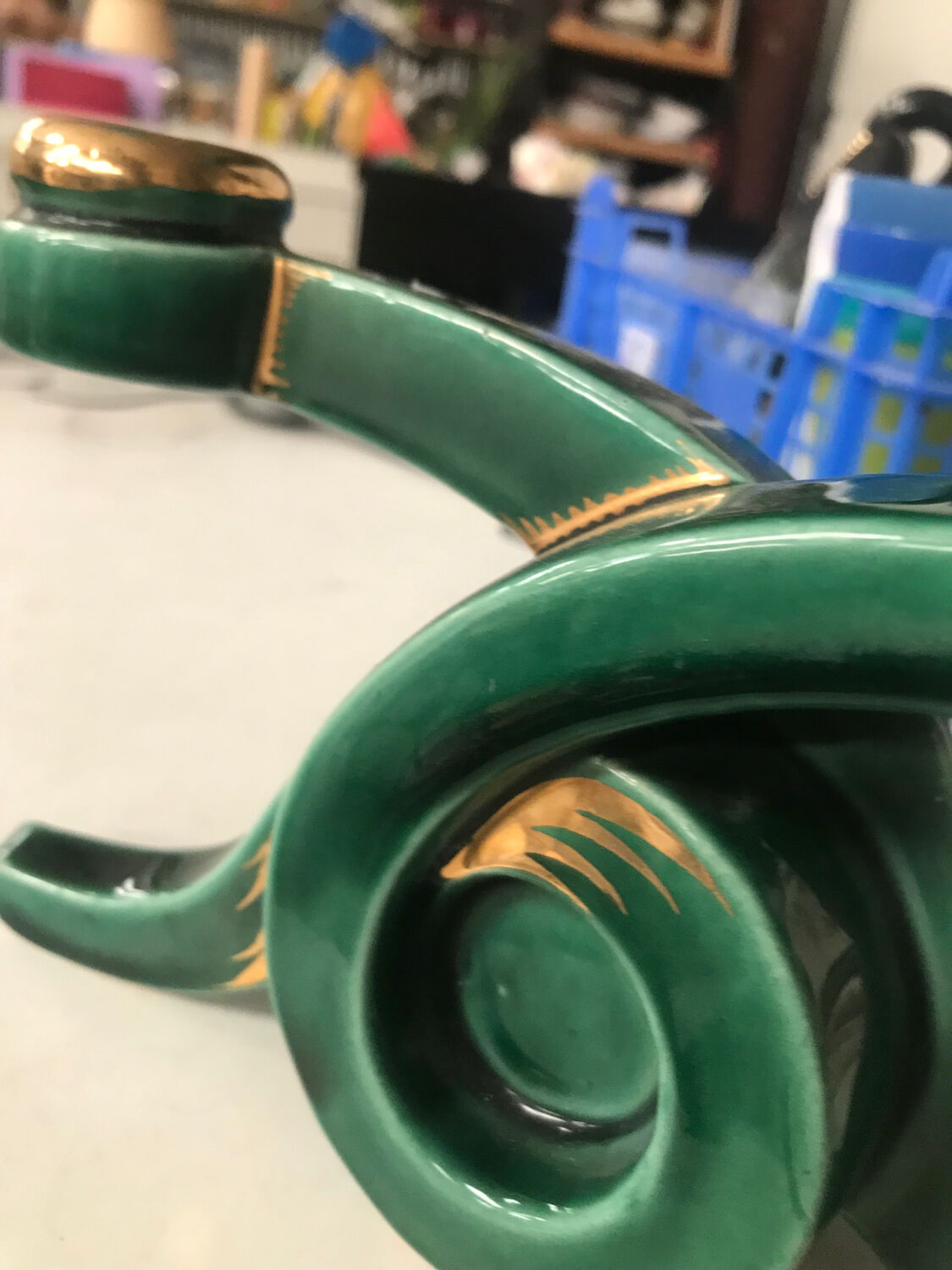 Art Deco candlestick in green and gold earthenware.