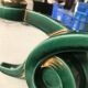 Art Deco candlestick in green and gold earthenware.