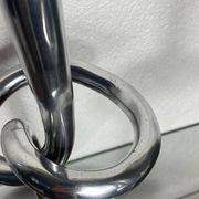 Pair of large aluminium bow candlesticks, Italy, 1970.