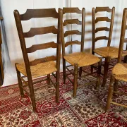 Set of 5 antique solid oak chairs with straw seats.
