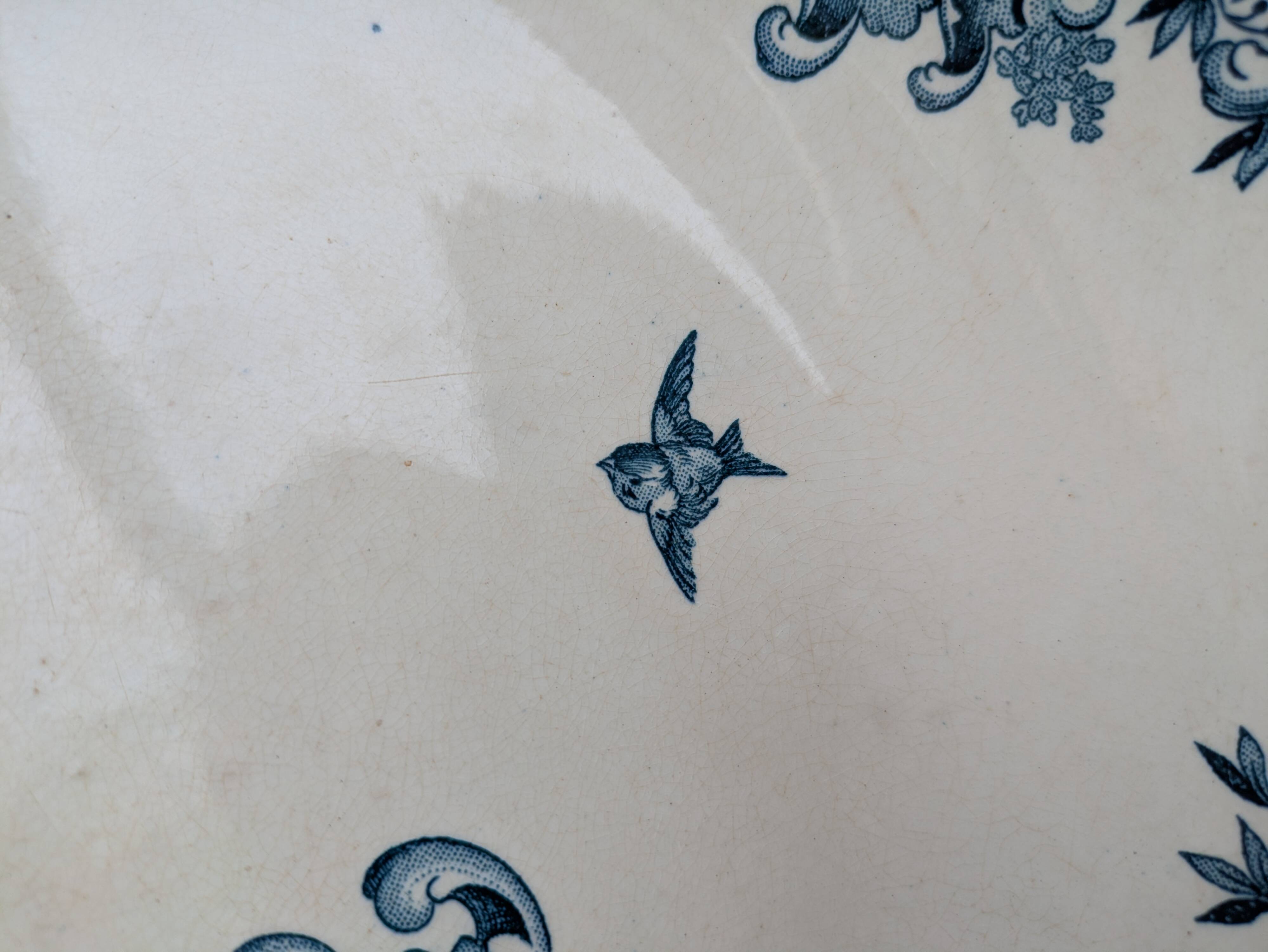 Shallow round plate Boch Frères model Regent with arabesque and foliage decoration.