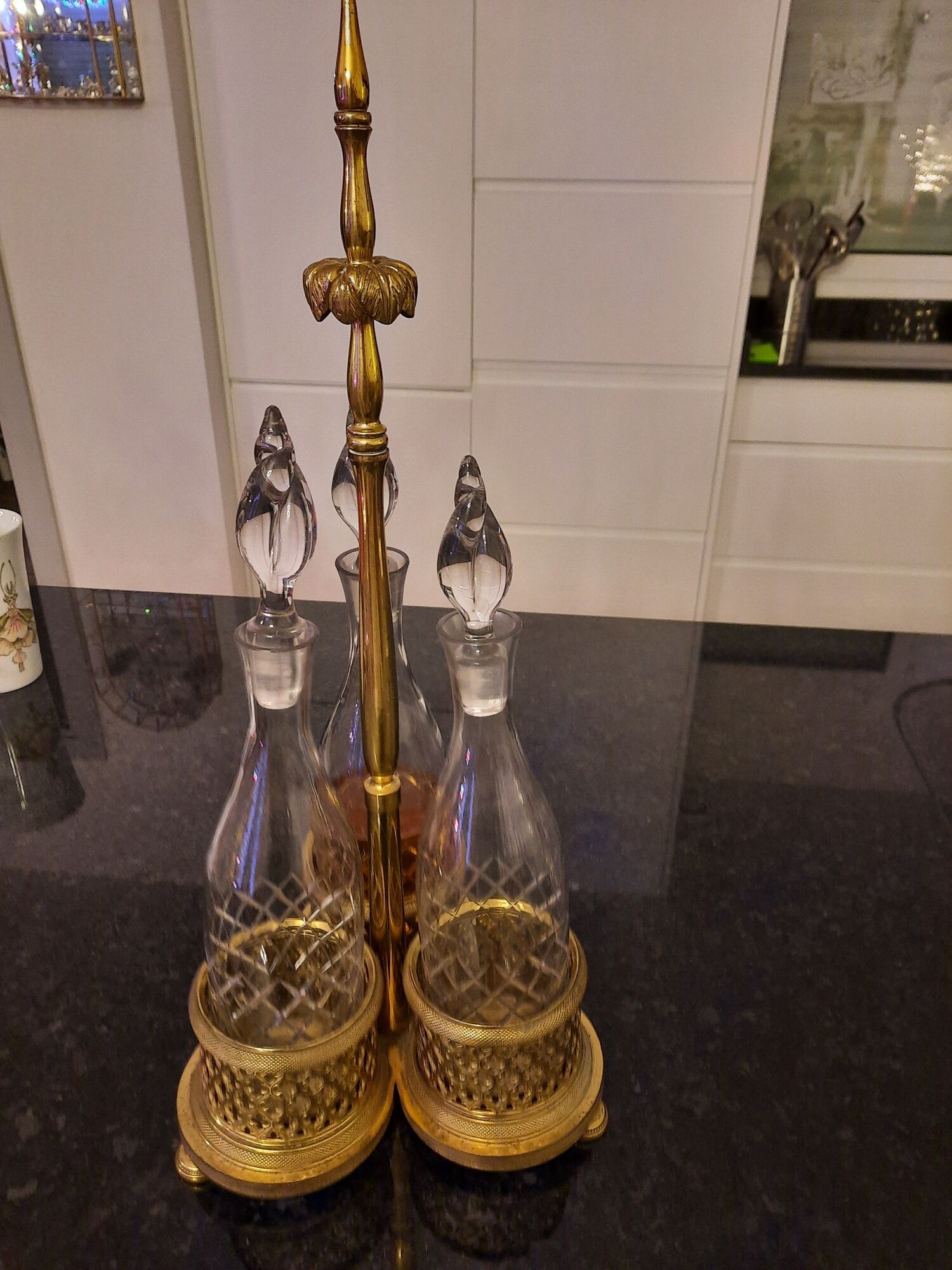 3 crystal decanters diamond cut set of 3 crystal decanters in a gold gold support,