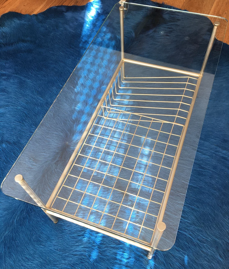 Glass coffee table with gold metal magazine holder