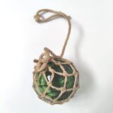 Green ball marine float in glass and rope