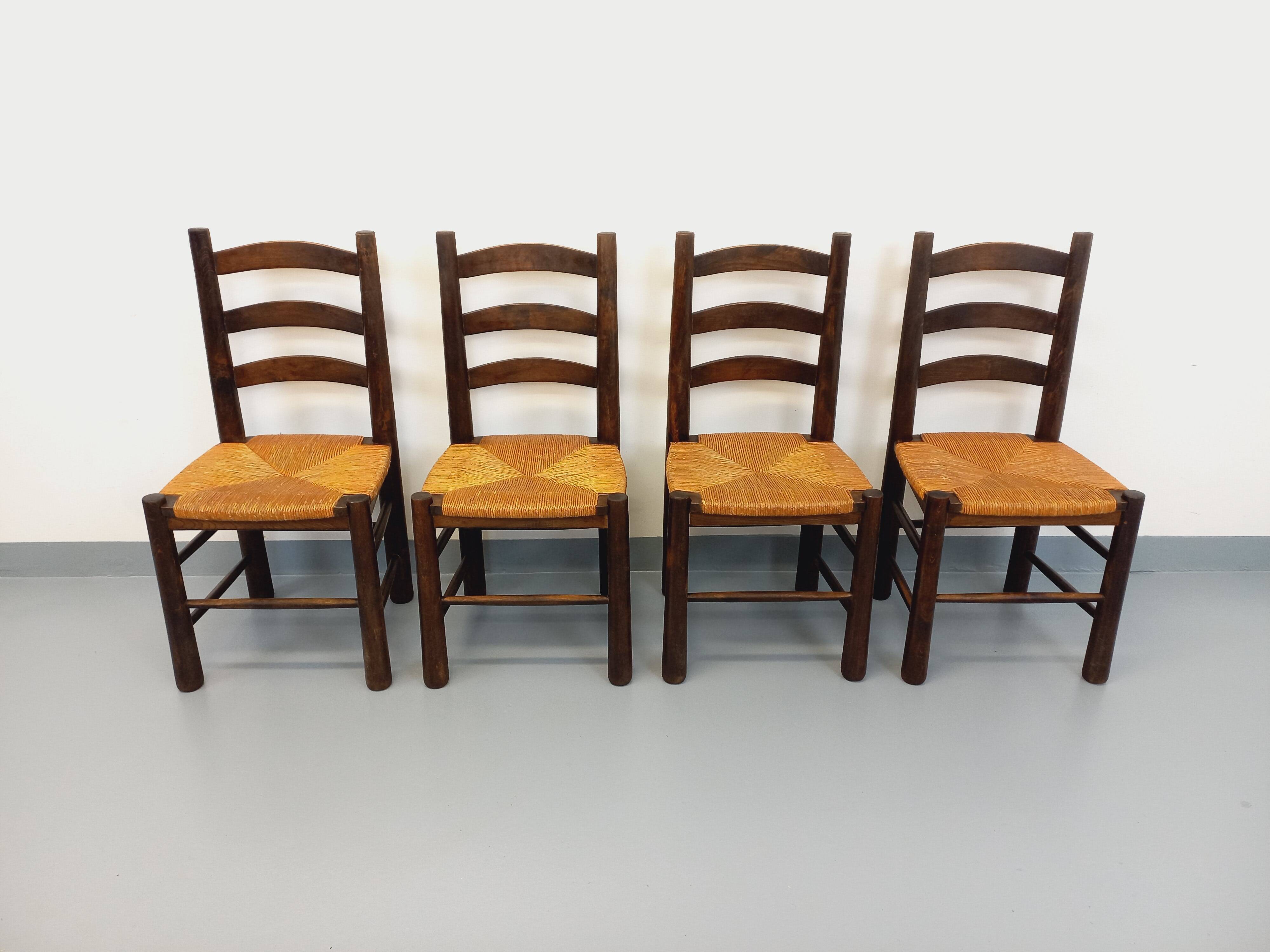 Set of 4 vintage brutalist chairs by Georges Robert in wood and straw.