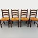 Set of 4 vintage brutalist chairs by Georges Robert in wood and straw.