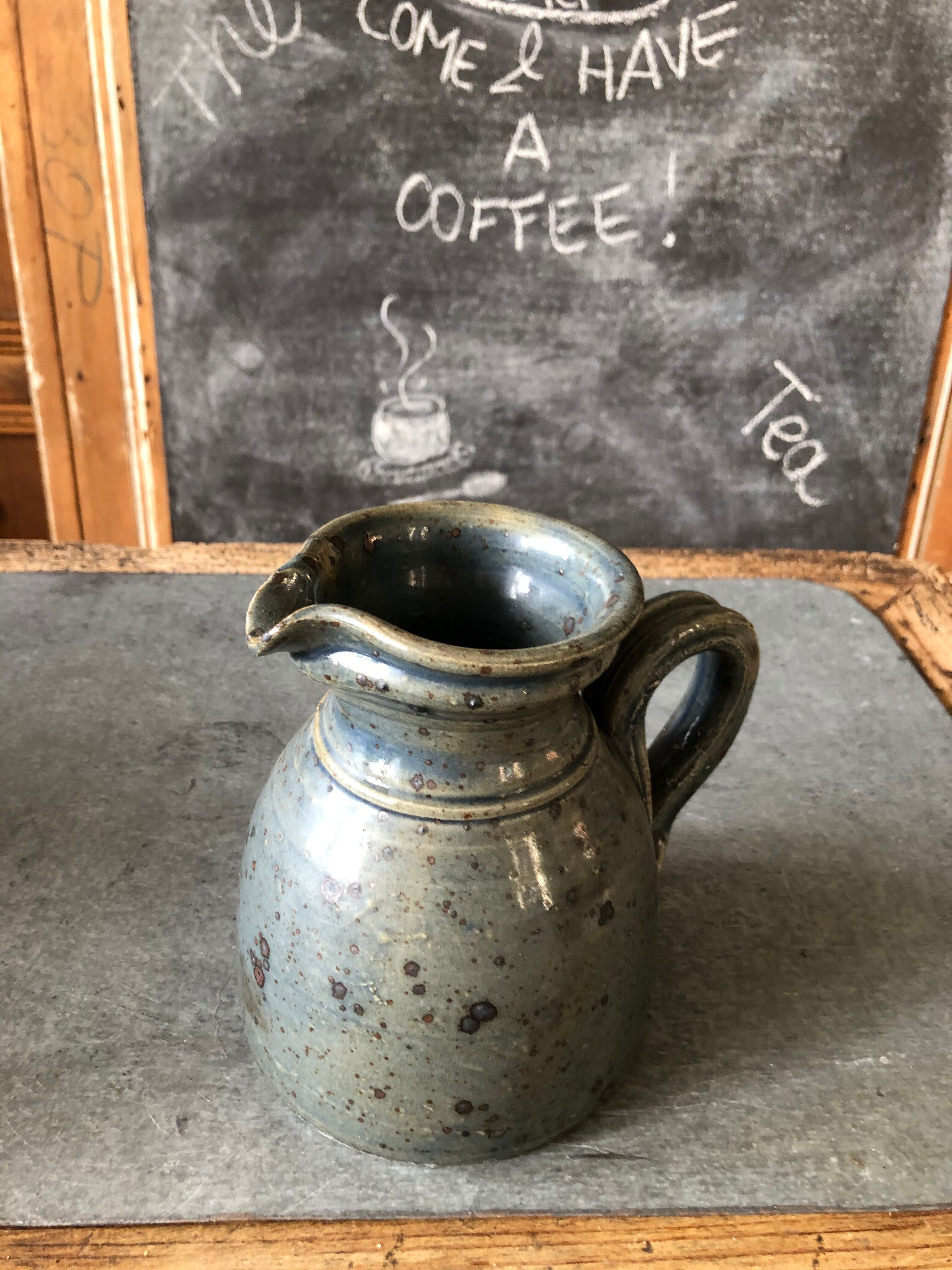 Handmade bluish enamelled sandstone pitcher speckled with brown