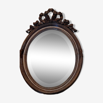 old oval mirror with carved pediment