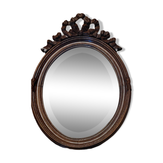 miroir ovale ancien avec fronton sculpté