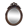 miroir ovale ancien avec fronton sculpté