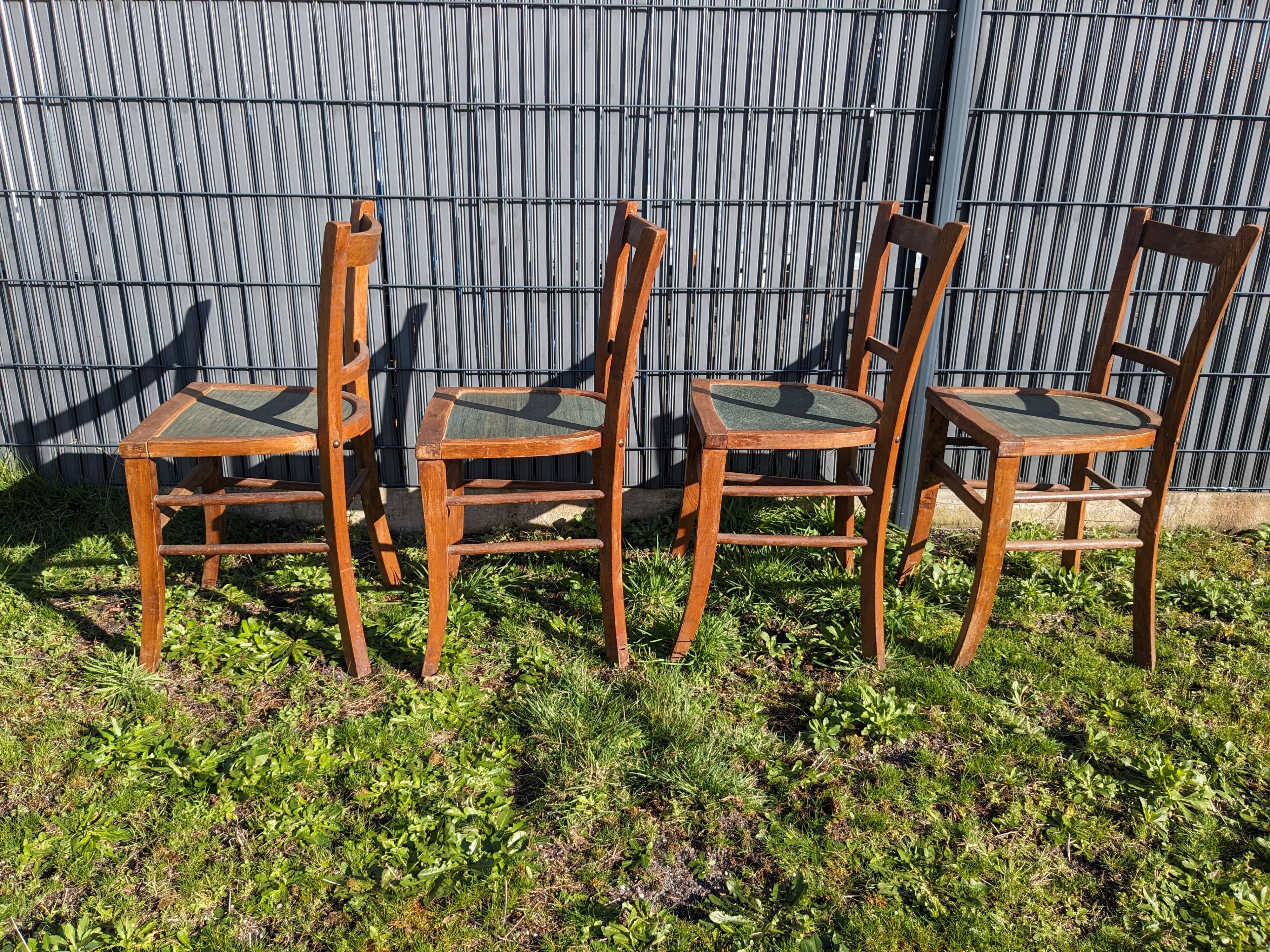 Set of four wooden bistro chairs, green seat, mid-20th century.