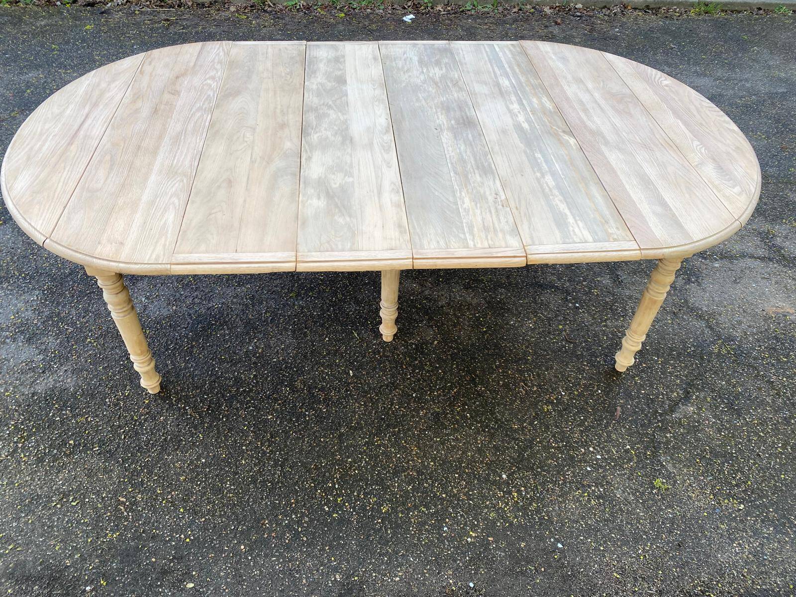 Renovated Louis Philippe round extendable dining table with 4 leaves.
