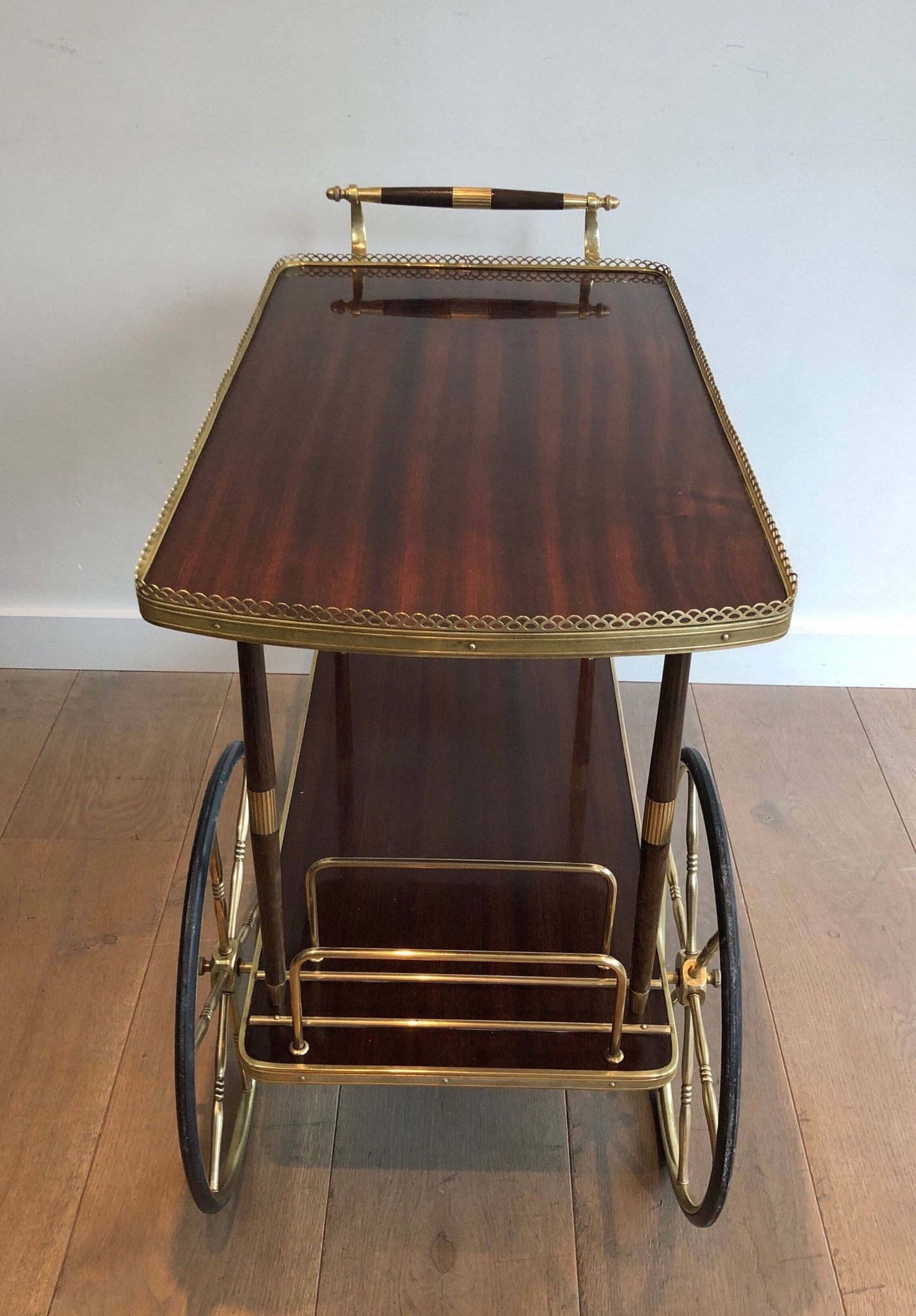 Mahogany and brass rolling table in the style of Maison Jansen.