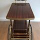 Mahogany and brass rolling table in the style of Maison Jansen.
