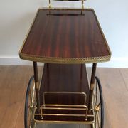 Mahogany and brass rolling table in the style of Maison Jansen.