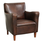 Subtle dark vintage sheepskin armchair with fixed seat cushion and timeless design